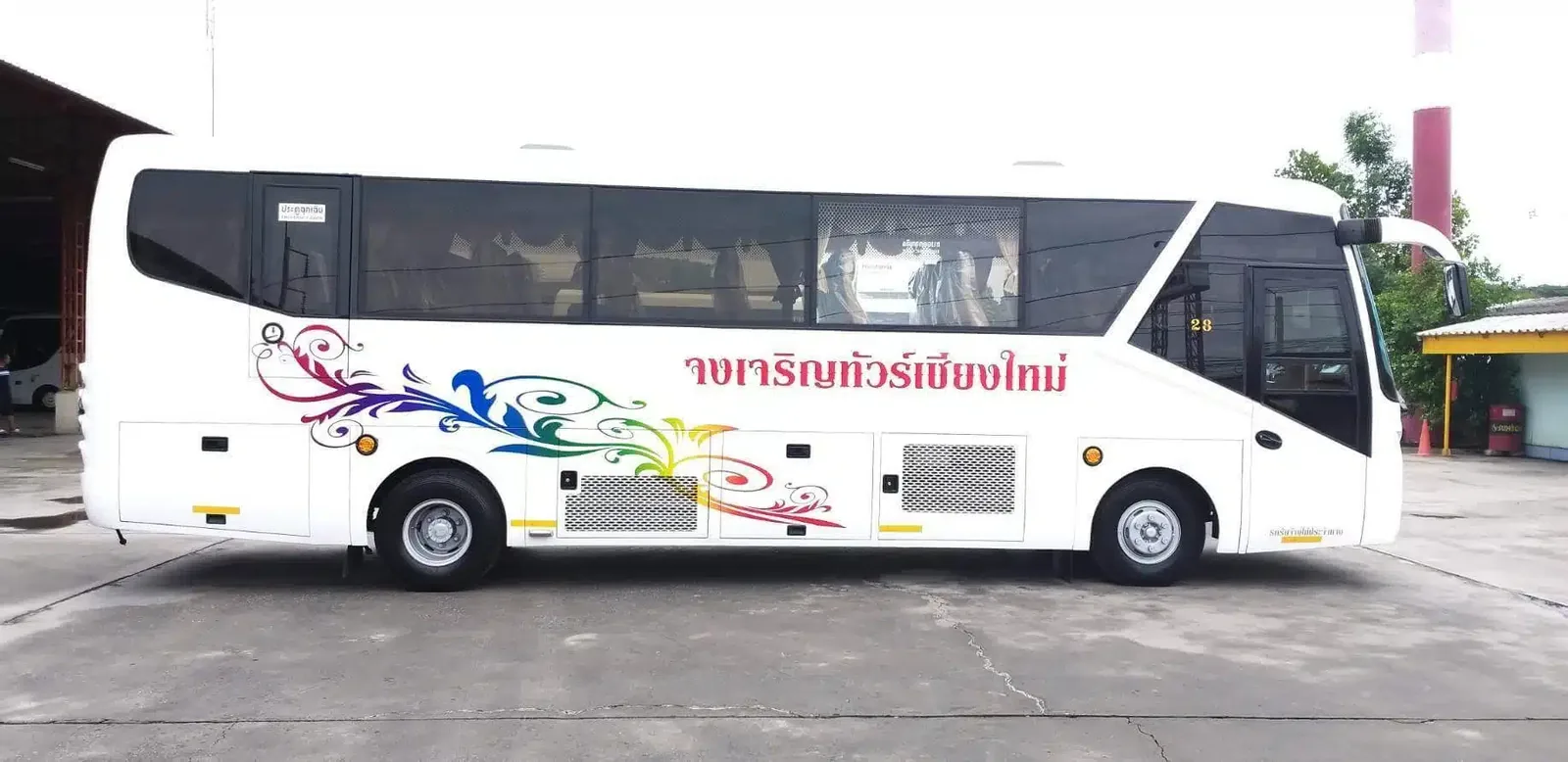 A white air-conditioned coach used for group transfers