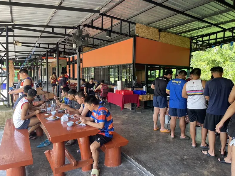 Players eating at outdoor tables beside the restaurant