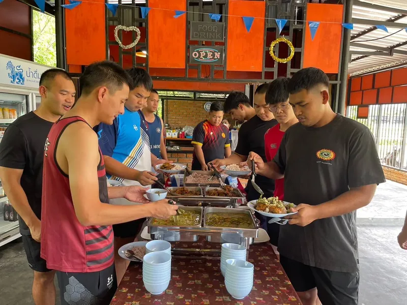 Players serving themselves from a hot buffet at the resort restaurant